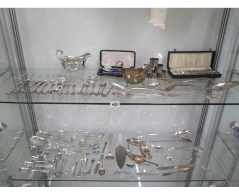 A large collection of silver and white metal to include: Edwardian silver sauce boat marked for Chester, silver trefid spoon,