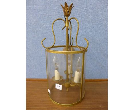 A brass and glass hanging light