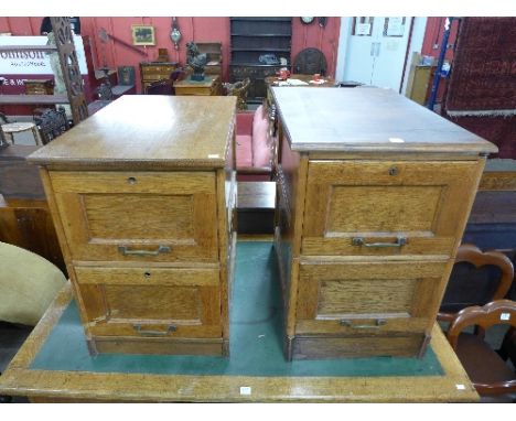 A pair of light oak filing cabinets
