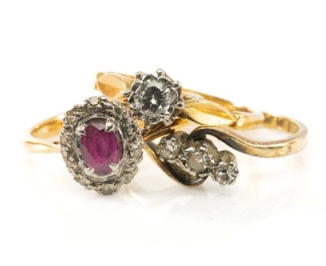 THREE 18CT GOLD & PLATINUM RINGS comprising ruby and diamond cluster ring, three stone diamond twist shank ring, and an illus