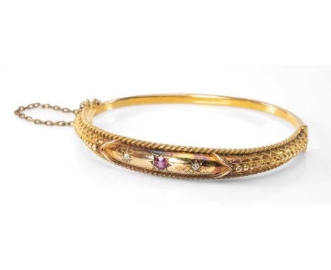 15CT GOLD DIAMOND & RUBY HINGED BANGLE, stamped '15CT', 13.5gms in Peter Earthy of Newbury jewellery boxProvenance: private c