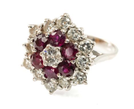 18CT WHITE GOLD DIAMOND & RUBY CLUSTER RING, the central diamond (0.2cts approx.) within a border of six rubies within a furt