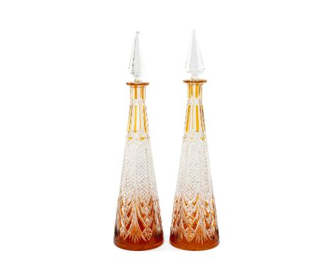 PAIR OF BACCARAT STYLE CONICAL TAPERING DECANTERS, clear with amber overlay, pyramid stopper, 42cms (h) (2)Provenance: privat