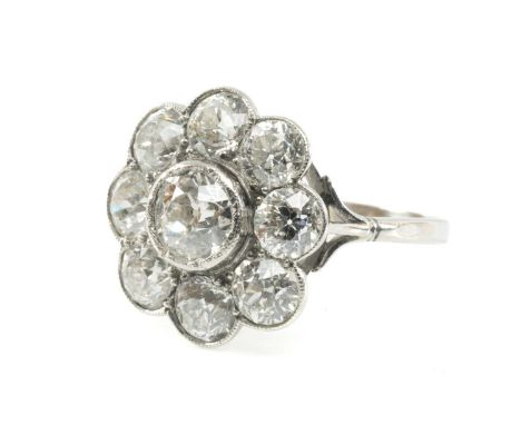 PLATINUM DIAMOND NINE STONE CLUSTER RING of flowerhead design, the central diamond (0.5ct approx.) within a border of eight f