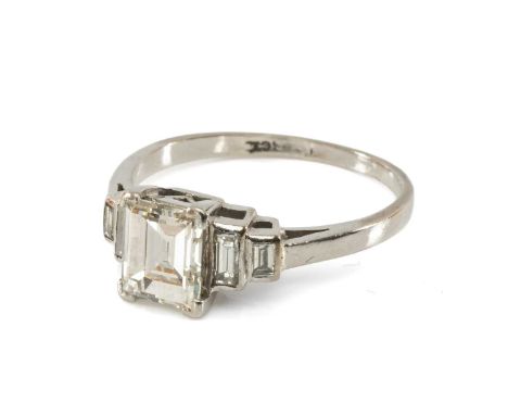 18CT WHITE GOLD FIVE STONE DIAMOND RING, the central emerald cut stone measuring 1.1cts approx., flanked each side by two gra