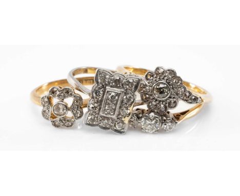 FOUR DIAMOND RINGS, comprising three 18ct gold examples (two flowerhead, one three stone) and a platinum Art Deco style ring,