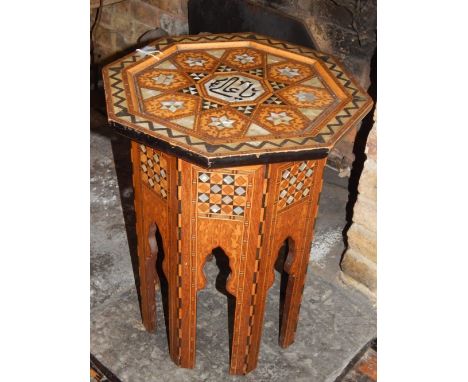 A late 19th century Damascus table, the octagonal top set with mother-of-pearl and hinged to reveal a button upholstered inte