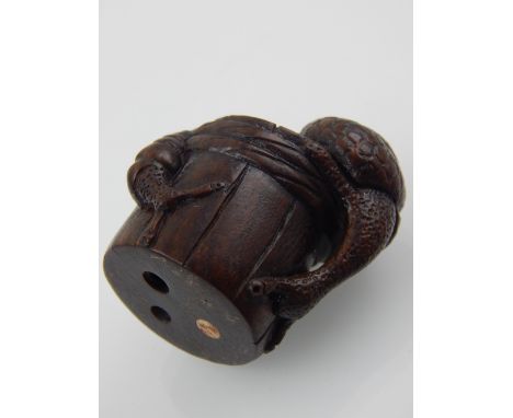 A Japanese Meiji carved boxwood netsuke, modelled as snails upon a staved wood cup, H. 4cm