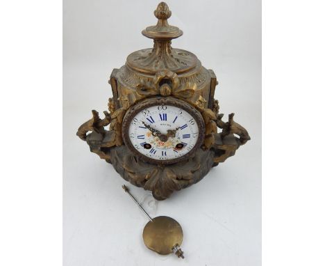 A late 19th century gilt metal mantel clock the eight day movement striking on a bell with circular floral enamel dial marked