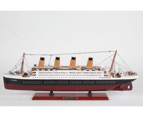 Model depicting RMS Titanic, on a red plinth base with name plate, 54cm long, 19cm high