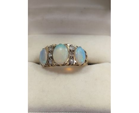 A three stone opal ring set in 9ct gold. Size M. 