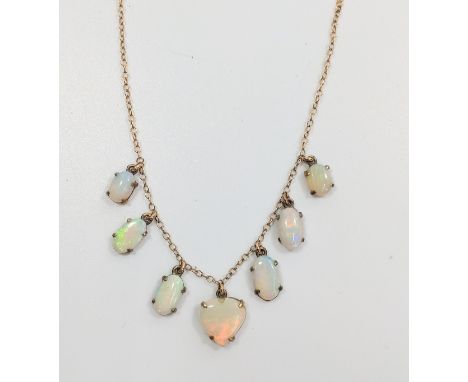 An opal necklace consisting of six polished opals including a heart shaped stone. 