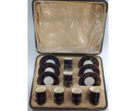 A cased coffee set for 6 people by Copeland Spode. The silver cup holders date to 1921 in the Art Nouveau style.