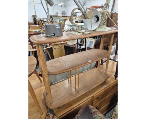 An Ercol pale elm three tier wheeled stand.