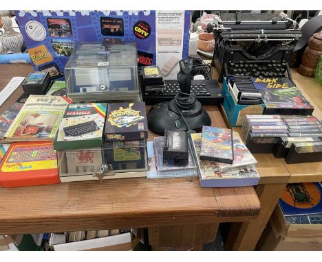 A boxed Amiga 500 computer, a Microsoft games console, games cassettes, diskettes in storage boxes, an Underwood type writer,
