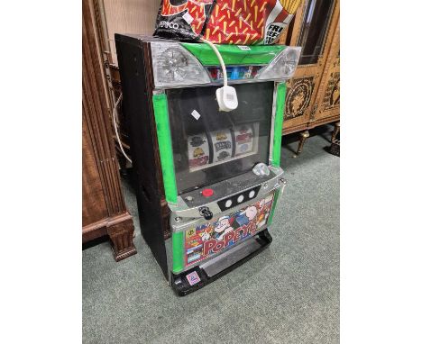A "Popeye" slot machine with tokens.