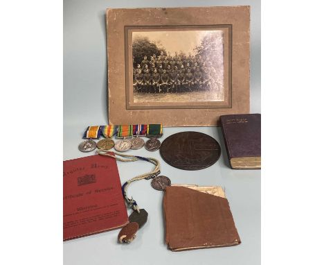 A set of four medals belonging to PTE. T. R. Ibbotson and one other, two military photographs, his service book and certifica