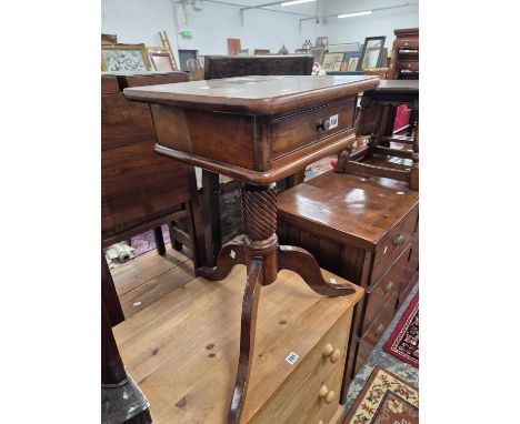 A tripod based occasional table.