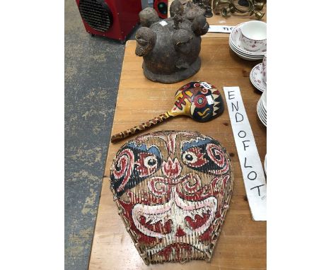 An African carved wood helmet mask, a South American painted wooden ladle and a Chinese basket ware mask