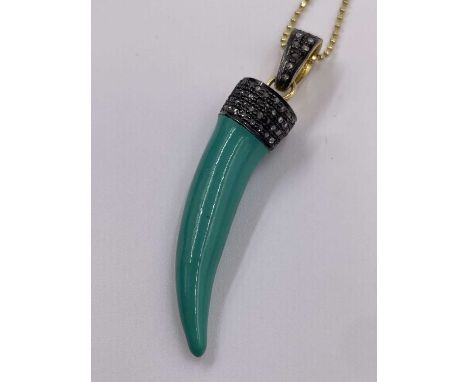 A turquoise enamel tiger tooth style pendant set to the top with old rose cut diamonds in silver and gold plate. Diamond weig