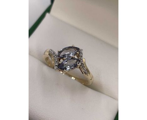 A 9ct, hallmarked gold double marquise cut lilac tourmaline and diamond ring.  Weight 2.44 grams. Ring size P.