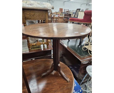 An antique oak topped tripod table.