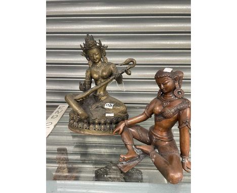 An Indian bronze goddess seated on a double lotus throne playing a stringed instrument together wih an Indian copper rich fig