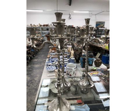A set of three chrome five light candelabra