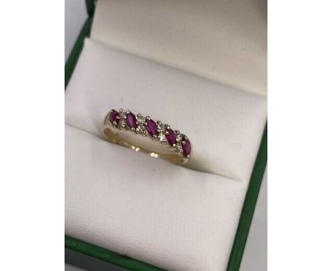 A 9ct hallmarked gold nine-stone marquise ruby and diamond ring. Size O 1/2. Weight 1.82 grams