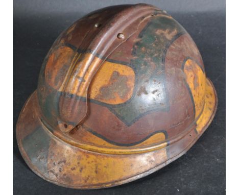 A WWI First World War period French M15 steel combat Adrian helmet with camo paintwork. Steel construction with split pin ' c