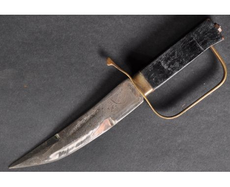 A vintage 20th Century Middle East / Persian dagger. Wooden grip with brass stirrup hilt and a clipped blade etched with Pers