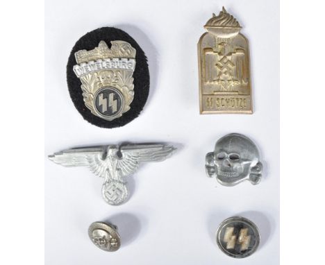 A collection of assorted WWII Second World War style Third Reich Nazi German SS cap and pin badges to include; SS ' Death Sku