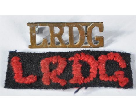 A WWII Second World War British&nbsp;Special Forces LRDG Long Range Desert Group brass shoulder title and cloth patch. The pa