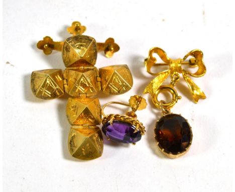 A 9 carat gold citrine bow pendant/brooch, measures 2cm by 3.5cm; a single amethyst earring stamped '9CT'; and a Masonic fob 