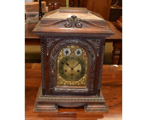 ~ Carved oak quarter striking mantel clock, movement backplate stamped Junghans