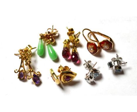A pair of 9 carat gold ruby stud earrings; a pair of 18 carat white gold aquamarine stud earrings; a pair of blue topaz stud 