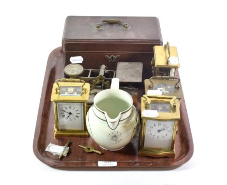 A serpentine fronted brass carriage timepiece; a Schatz eight day timepiece, two brass carriage timepieces; a set of postal s