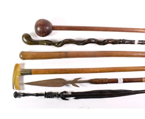 A collection of various sticks including a knobkerrie, spear, silver collared walking stick etc (7) 