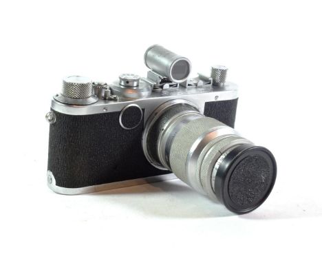 A Leica camera and 135mm lens 