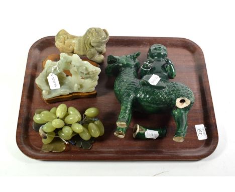 A Chinese jade temple lion; with a jade landscape carving both with wooden stands; with two others (a.f.) (4)