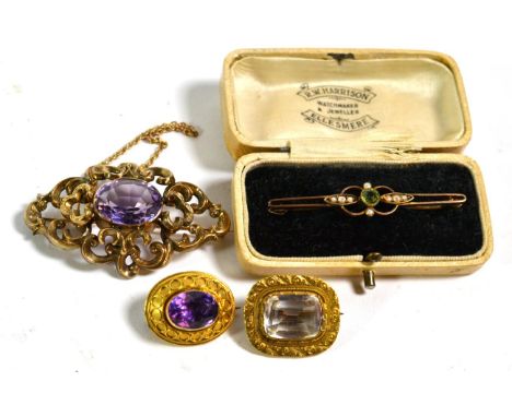 An amethyst brooch, length 2.2cm; a blue stone brooch, length 2.3cm; a peridot and seed pearl bar brooch, length 5.0cm; and a