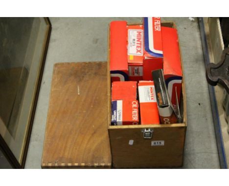 A quantity of car spares including vintage Champion spark plugs, filters etc in a wooden box