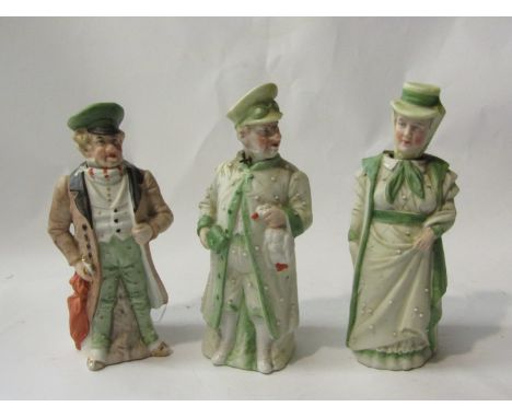 A pair of Victorian bisque nodding figures of motoring couple and one other 