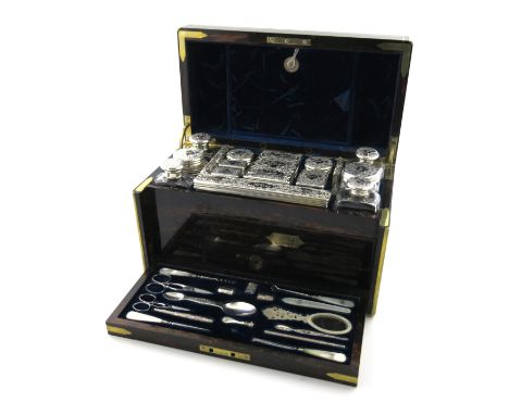 λA Victorian silver travelling dressing table set, retailed by W. Leuchers, 18 Piccadilly, the silver by Thomas Johnson, Lond