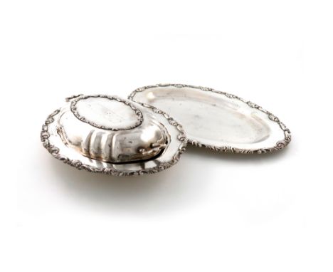 A Peruvian silver entrée dish and cover and a meat platter, maker's stamp of Kohler, .900 standard, oval form, foliate scroll