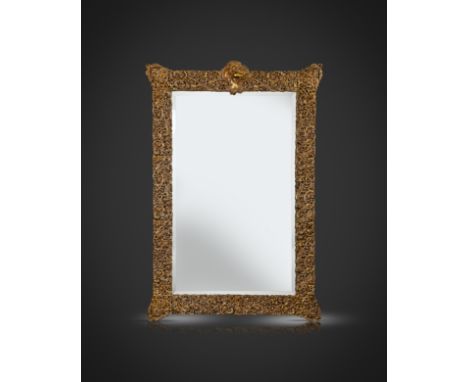 A large late-Victorian silver-gilt easel mirror, apparently unmarked, circa 1890, upright shaped rectangular form, pierced an