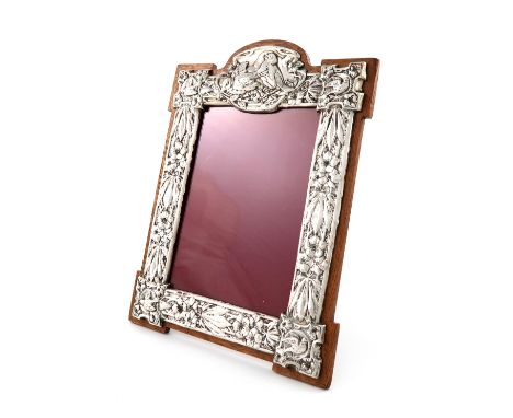 An Edwardian silver photograph frame, by Gourdel Vales &amp; Co, Birmingham 1904, shaped upright rectangular form, embossed w
