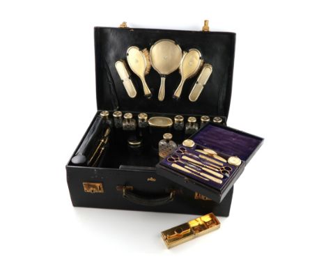 λA silver-gilt travelling dressing table set, by J. Vickery, London 1924, with engine-turned decoration and swag borders, wit