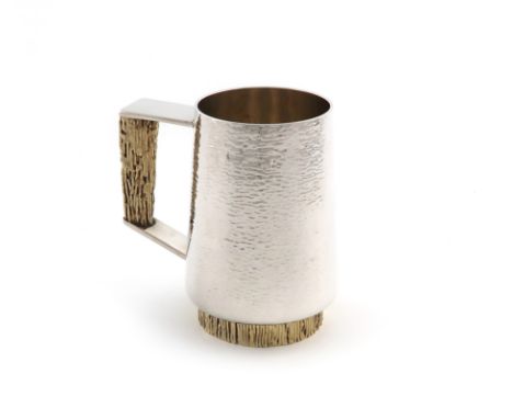 By Stuart Devlin, a modern parcel-gilt silver mug, London 1974, tapering circular form, textured decoration, angular scroll h