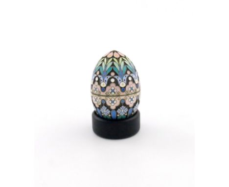 A Russian silver-gilt and enamel egg, 1896-1908, with pink and blue/green decoration on a matted background, wire-work border